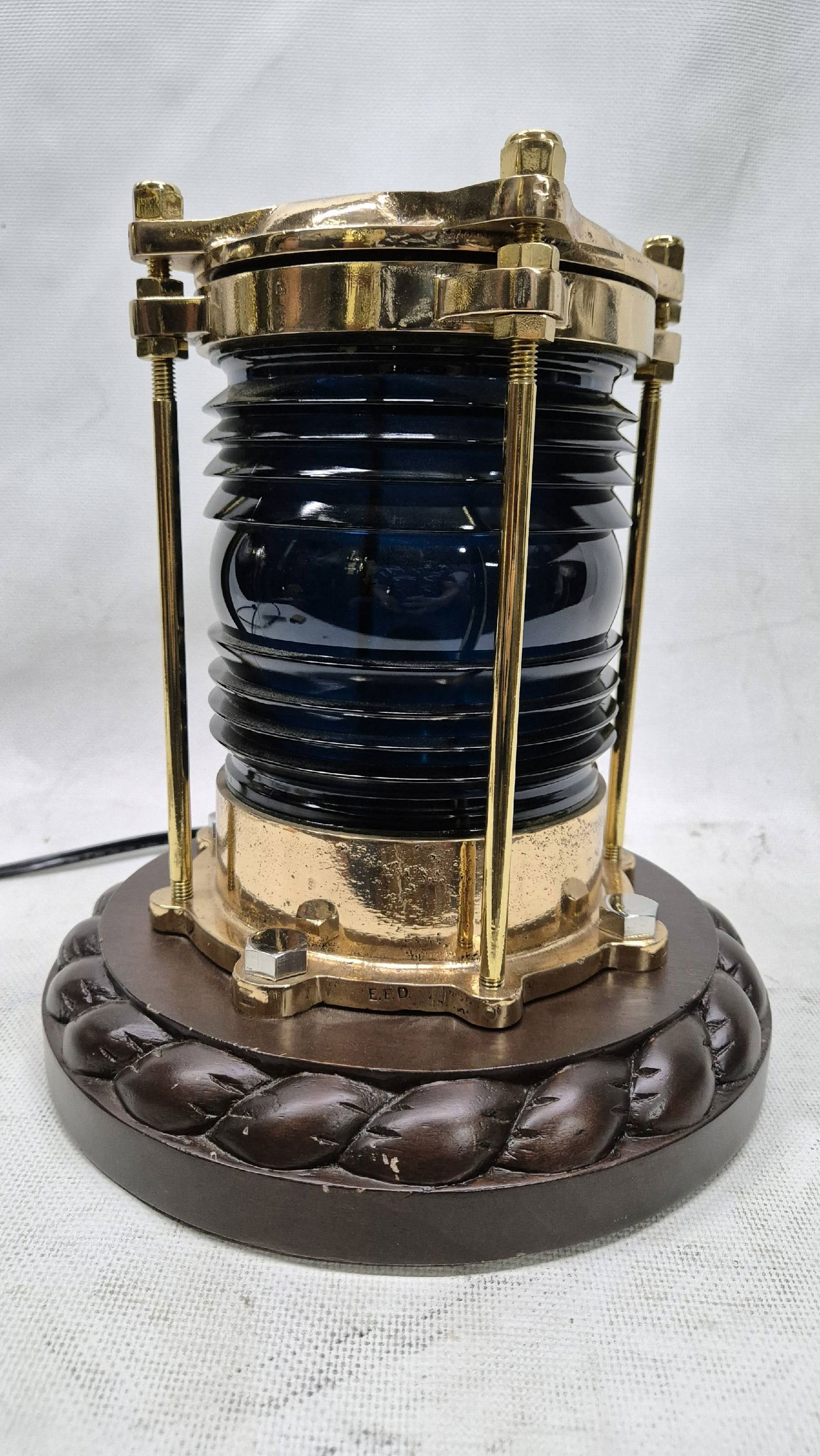 Brass Marine Beacon With Fresnel Lens On Stand: Choice marine beacon with rich blue green Fresnel lens. Highly polished and lacquered. Mounted to a custom binnacle style base with rope carving