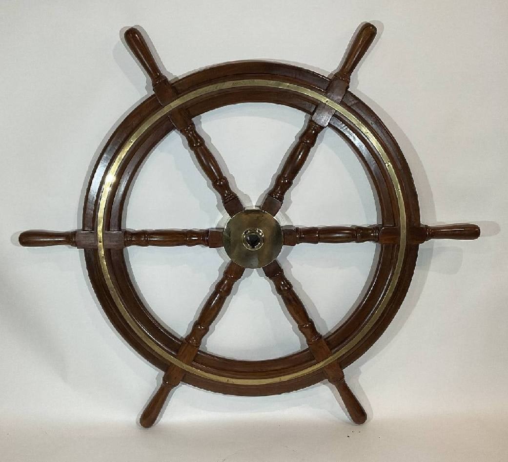 Six Foot Ship's Wheel with Massive Brass Hub: Ship's wheel with hardwood frame and six turned spokes. Large solid brass hub with keyhole and brass trim ring. Nice varnished finish. 6 feet Diameter.