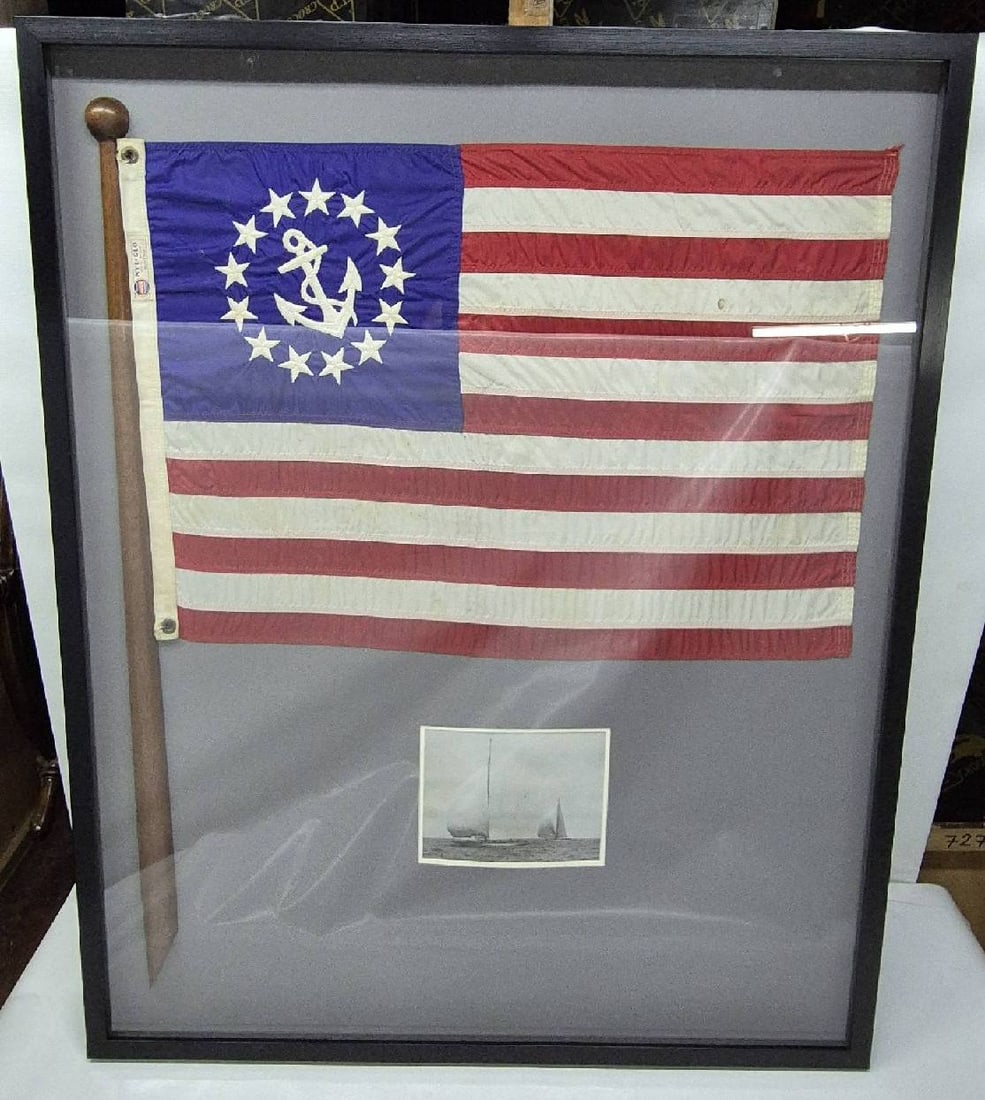 Old Yachting Ensign Flag in a Shadowbox Frame: Antique boat flag with a fouled anchor and thirteen stars in the blue field. The United States yachting ensign was created by Congress in 1848 to identify yachts that didn't need to clear customs