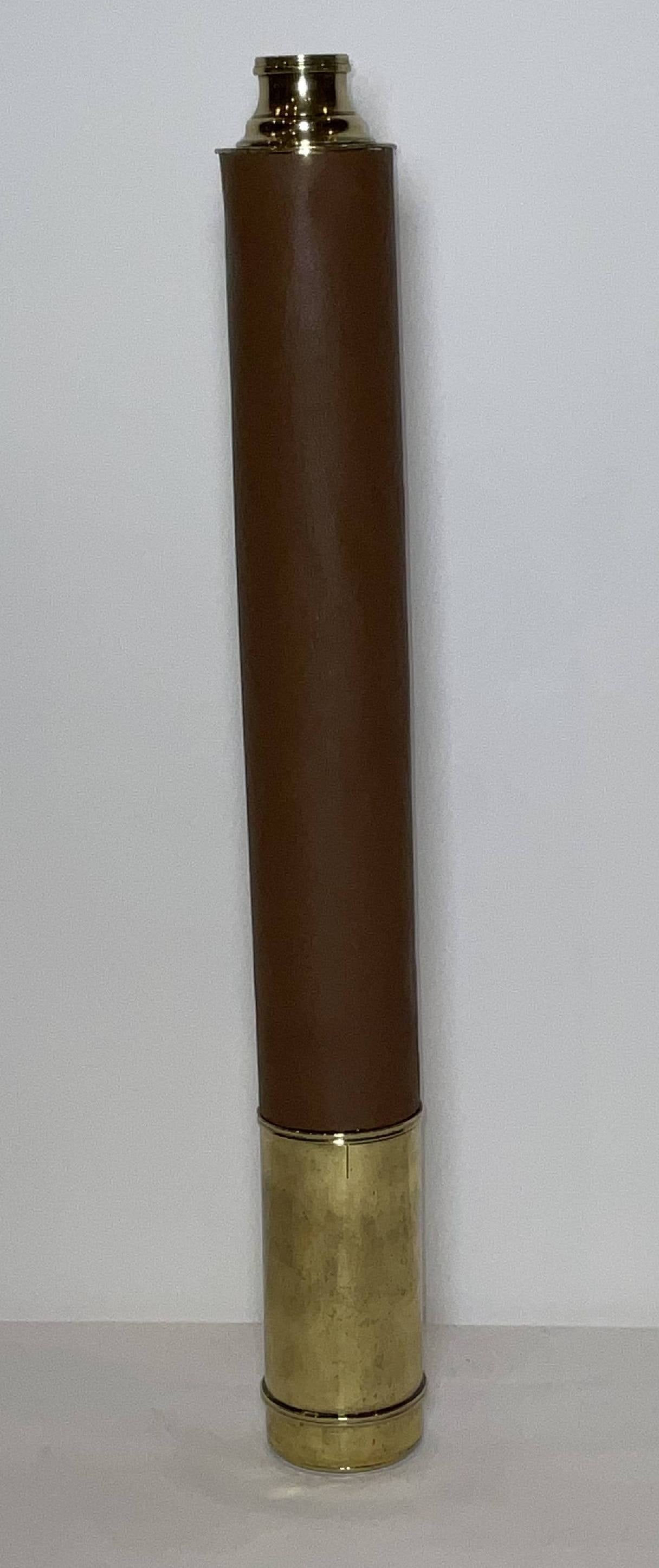 Single Draw Ship's Spyglass with Brown Leatherrette Cover: Solid brass ship captains spyglass with single draw focal tube. The barrel is covered in brown leatherette. 3 lbs. 35"W open. 20"W.