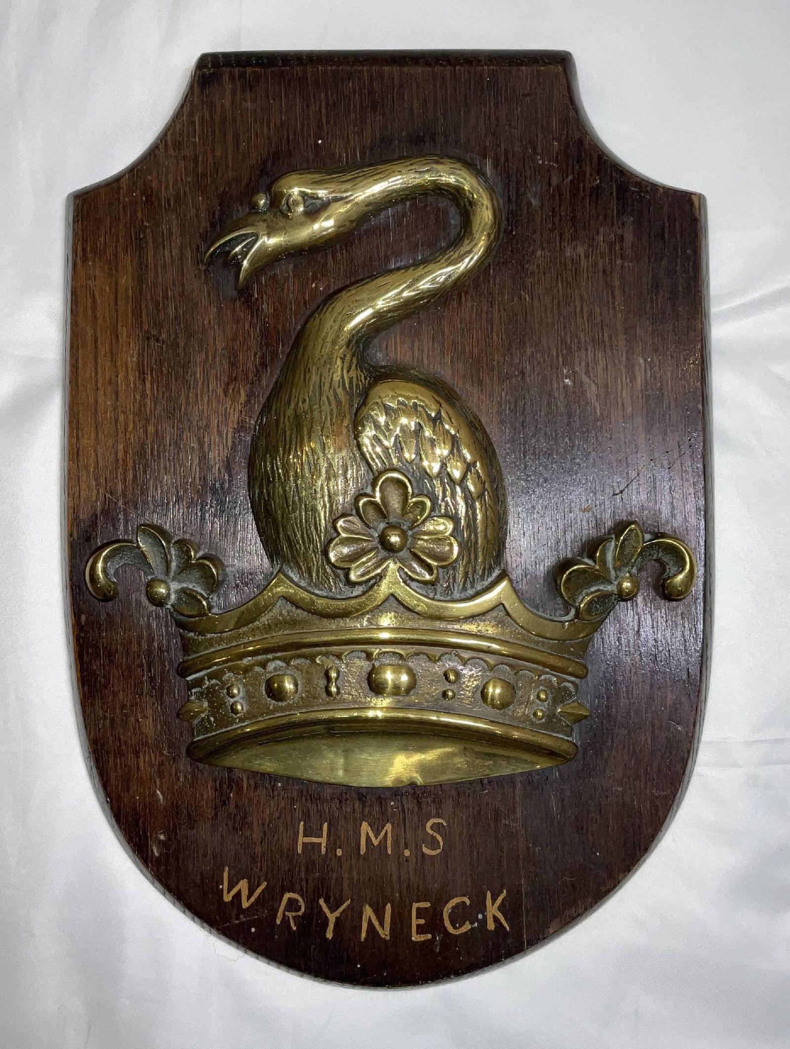 Brass Badge from Royal Navy Warship HMS Wryneck: Solid brass ship's badge or gun tompion from HMS Wryneck, an Admiralty "W" class destroyer. HMS Wryneck was launched in 1918 and sunk in 1941 during the Battle of Greece. The brass badge shows a bird