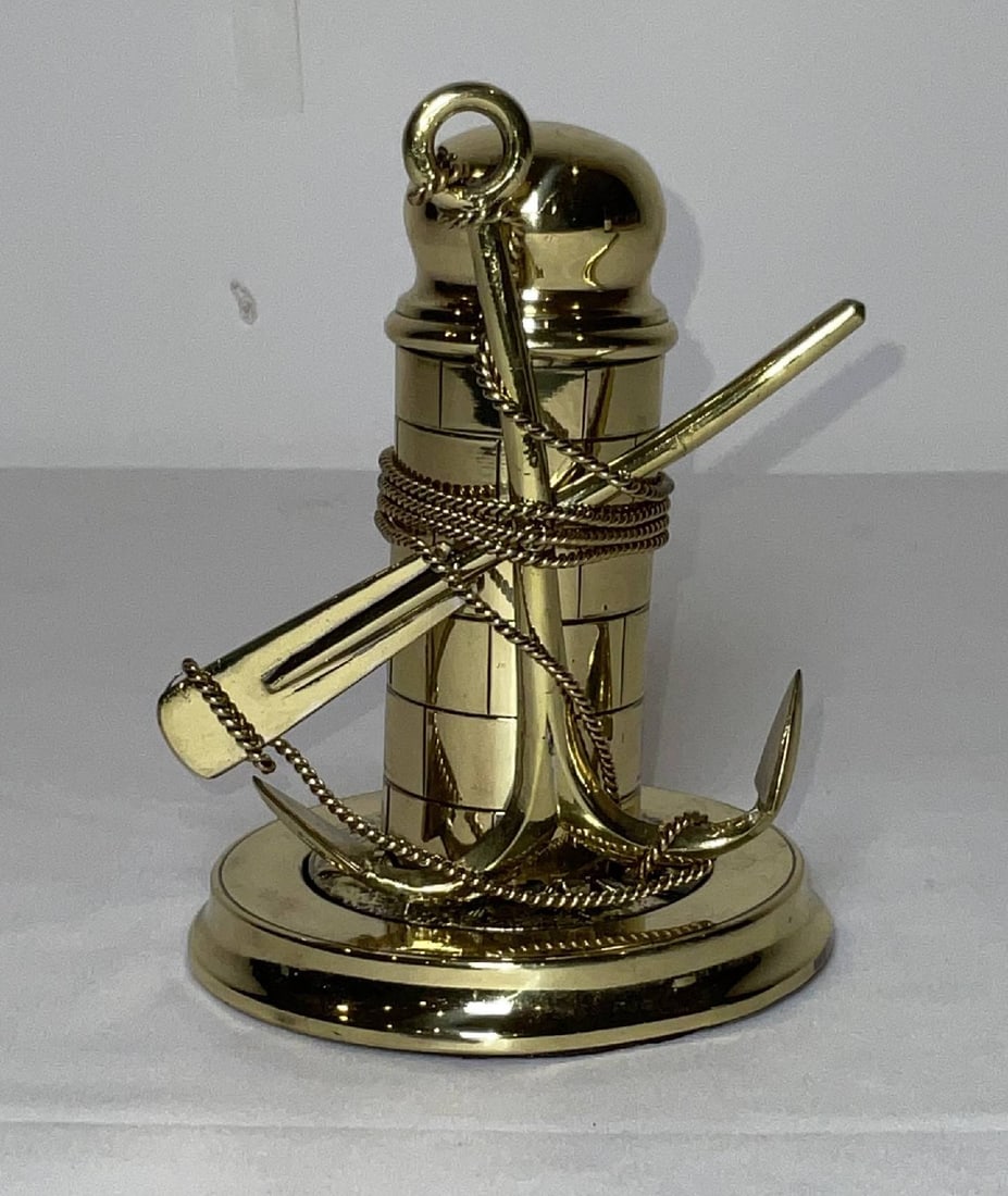 Solid Brass Anchor and Lighthouse Inkwell Circa 1890: Antique nautical inkwell with anchor motif. Intricate detail and polished and lacquered to perfection. Probably French. Details include lighthouse, anchor, oar, and rope. Weighted base. 2 lbs. 5"H x 4