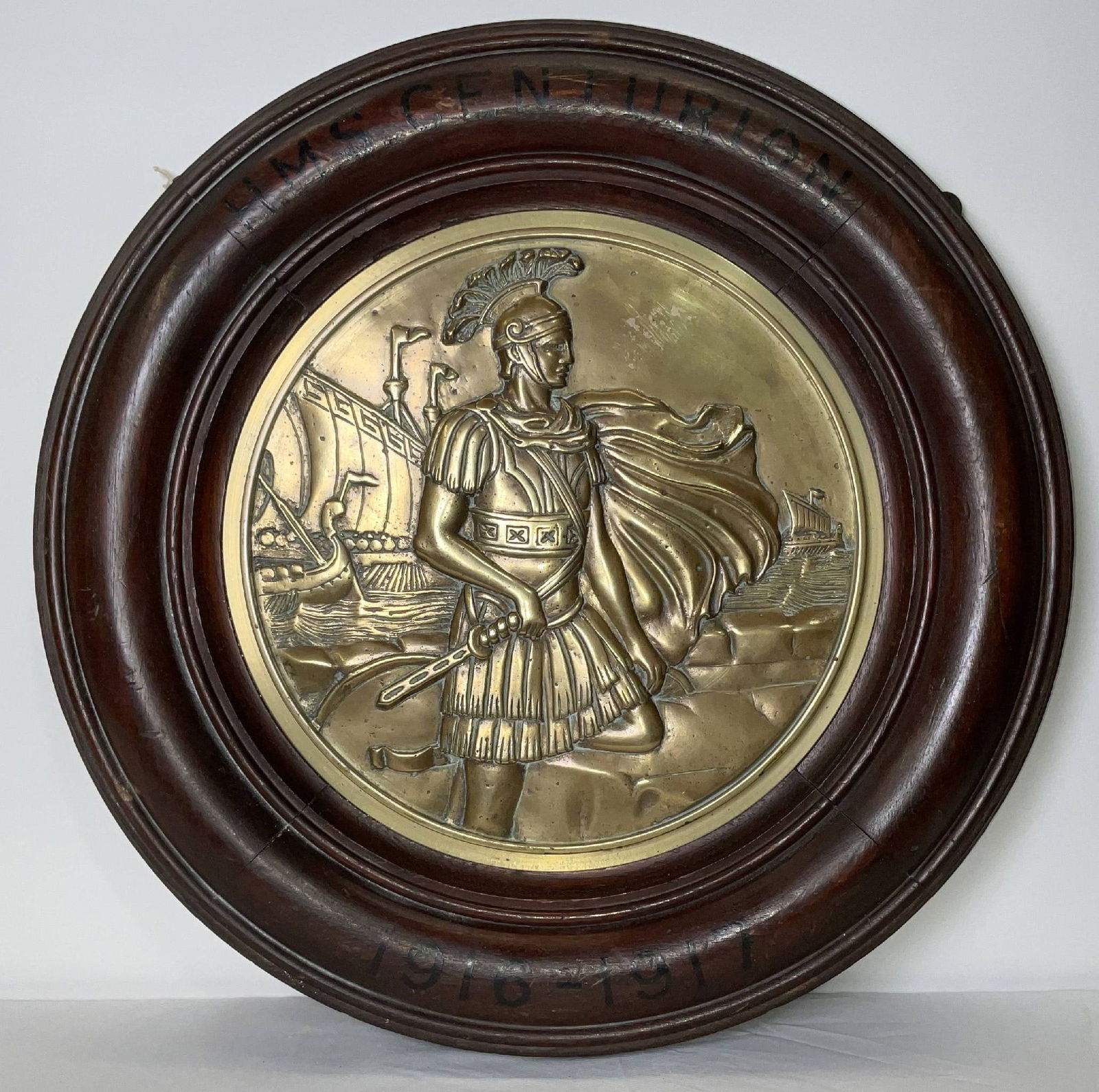 Tampion from the Royal Navy Battleship HMS Centurion: Tampion from the battleship HMS Centurion of 1911. Cast in brass and mounted into a wood frame. HMS Centurion was a "King George V" class battleship. From the collection of "Admiral of the Fleet" Baro