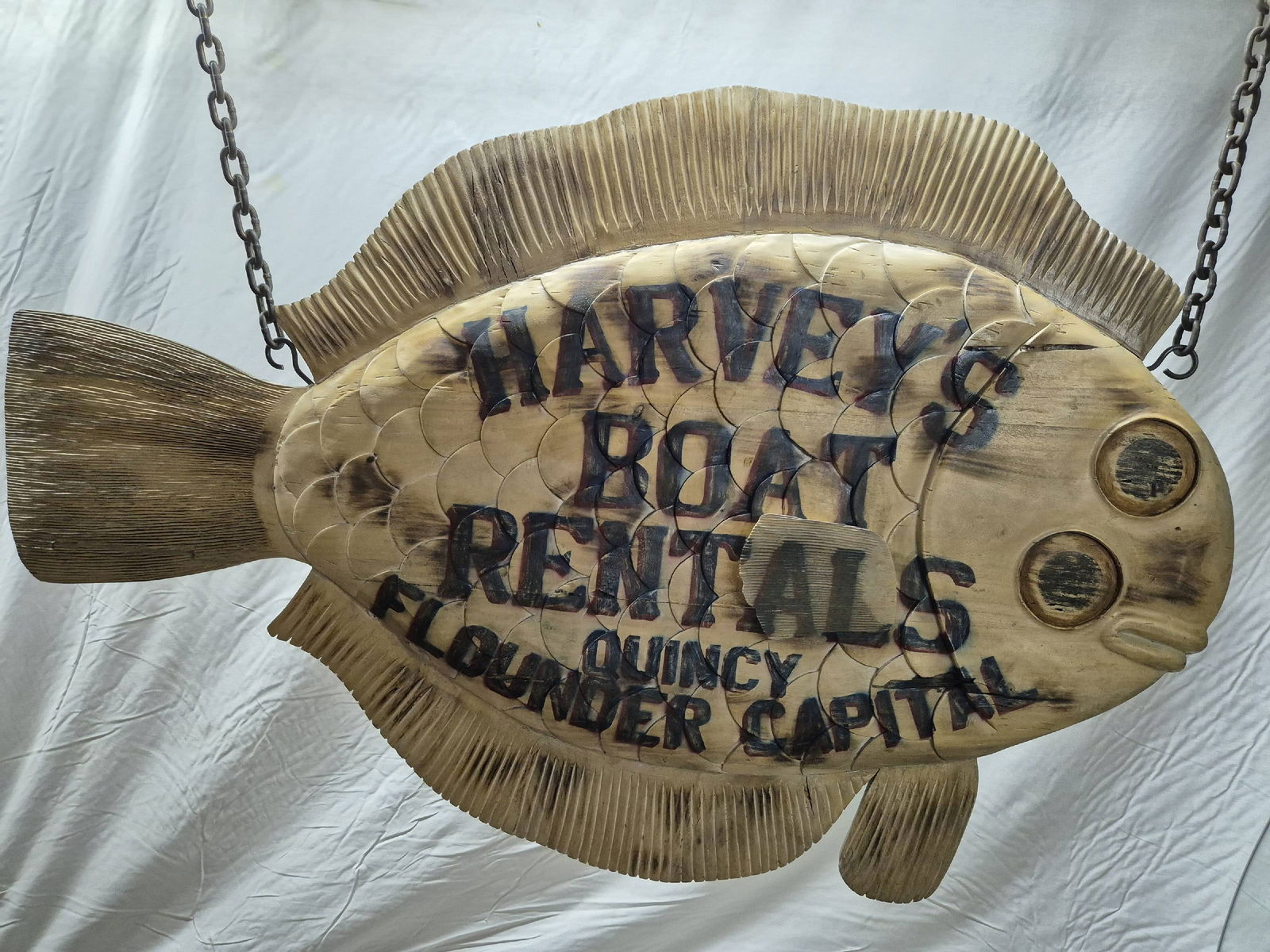 Carved Flounder Trade Sign: Carved wood fish trade sign. This flounder is fitted with iron hanging rings and chain.