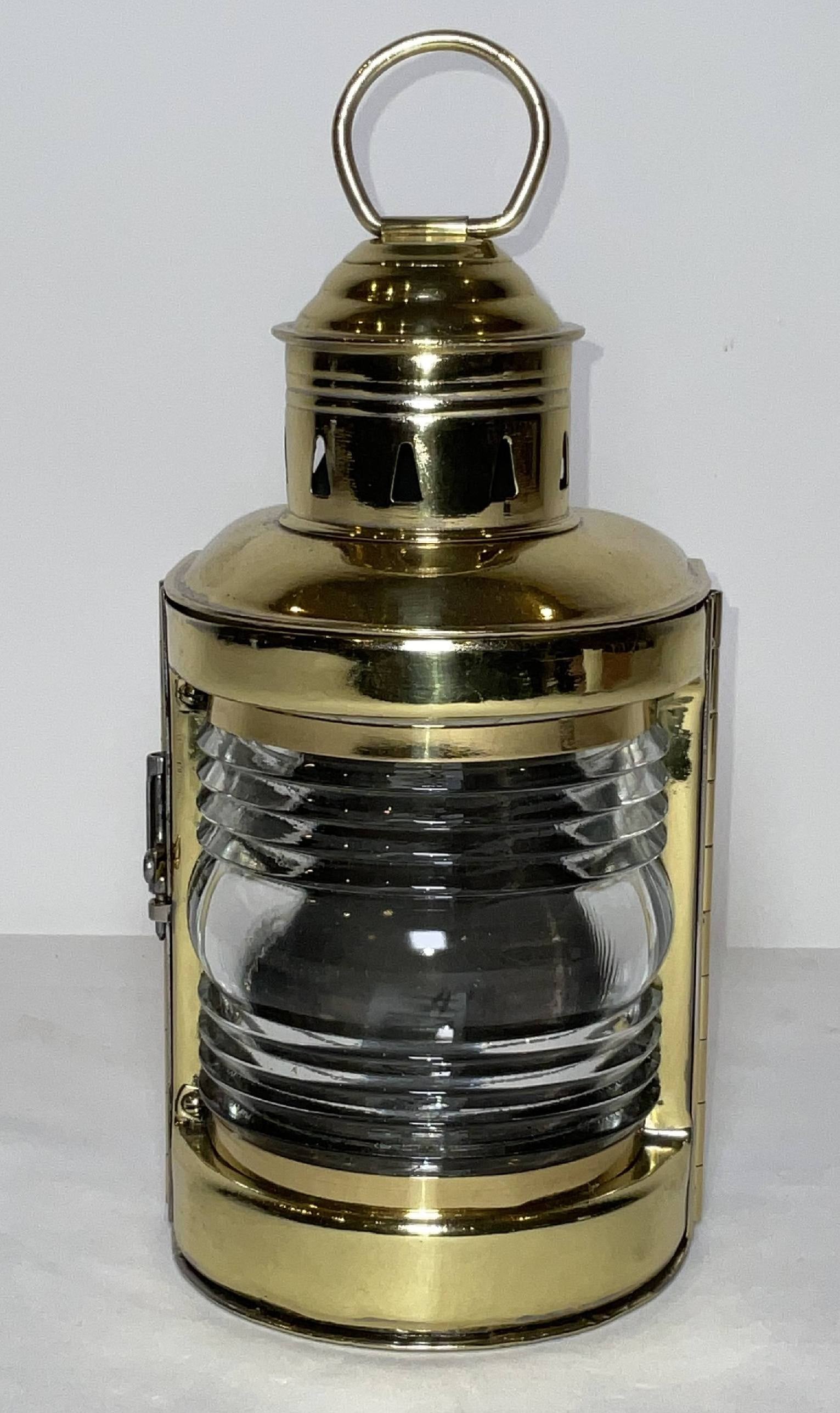 Solid Brass Boat Lantern by Perko: Brass bow lantern with a Fresnel glass lens and hinged door. Vented Chimney with handle nice old lantern that has been meticulously polished and lacquered. 5 lbs. 9"H x 5"W x 4"D.