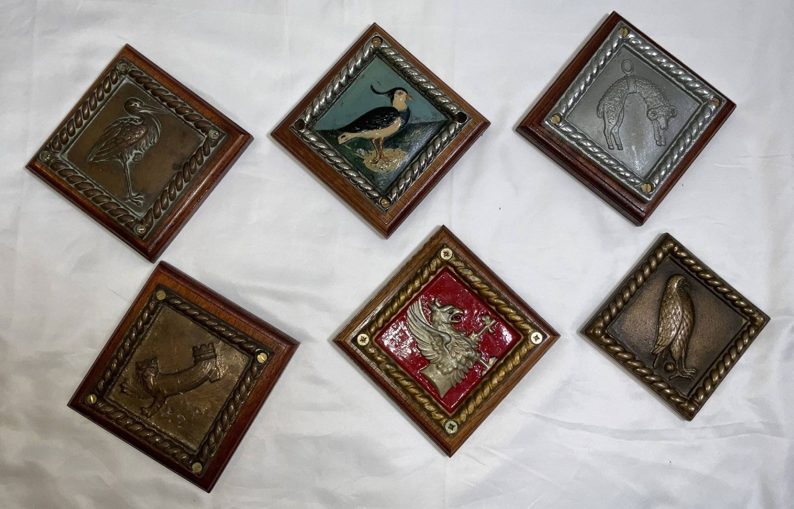 Six Chatham Pattern Ship's Badges from British Royal Navy Ships: Group of Chatham Dockyard cast ship's badges from HMS Stork, HMS Plover, HMS Jason, HMS Sandwich, HMS Protector and HMS Dundalk. Great group. 6 badges. 15 lbs. 5 1/2"H x 5 1/2"W large. 4 1/2"H x 4