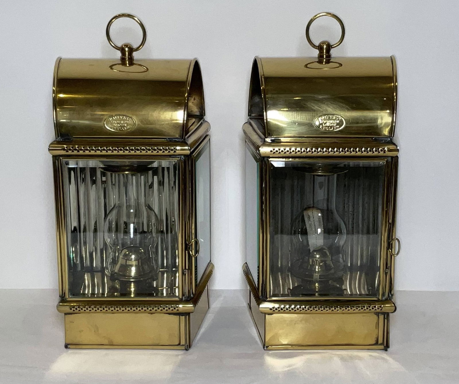 Pair of Exceptional Yacht Cabin Lanterns by Davey & Co Ltd, London: Yacht cabin lanterns from Davey & Co. London Limited. Solid brass and large in size, with original burners, chimneys, and hinged doors. Glass panels are bezelled. First class. 30 lbs both. 16"H x 8"W