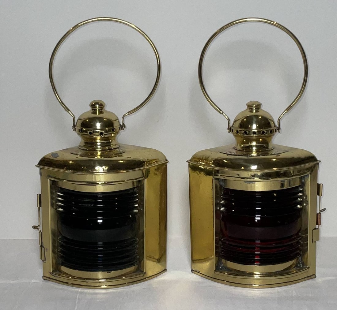 Pair of Port and Starboard Ship's Lantern with Fresnel Lenses: Solid brass port and starboard boat lanterns with Fresnel glass lenses, vented Chimney tops with large loop hoisting rings. With attached brass port and starboard badges. Circa 1890. 9 lbs both. 10"H