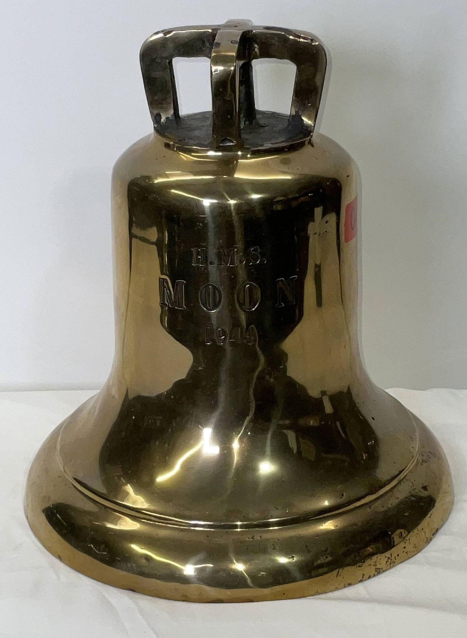 Bell from H.M.S. Moon (1944): Solid brass bell from the ship H.M.S. Moon, engraved “H.M.S. Moon 1944” fitted with a four canon crown mount cast into the bell. H.M.S. Moon was a Royal Navy vessel commissioned in 1944 for se
