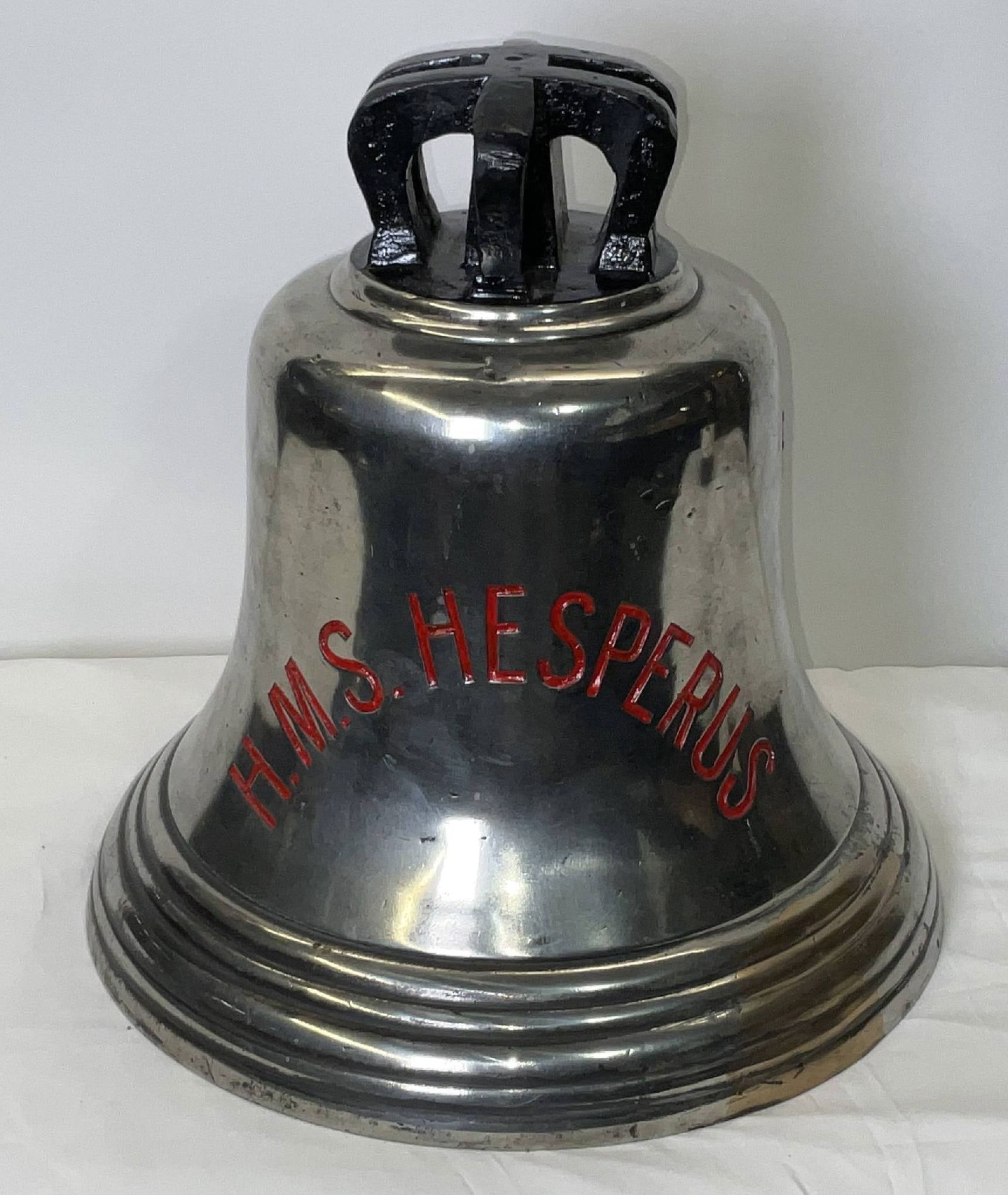 Bell from H.M.S. Hesperus: Solid brass bell from the ship H.M.S. Hesperus, engraved “H.M.S. Hesperus” fitted with a six canon crown mount cast into the bell. H.M.S. Hesperus was a H-class destroyer of the British Royal
