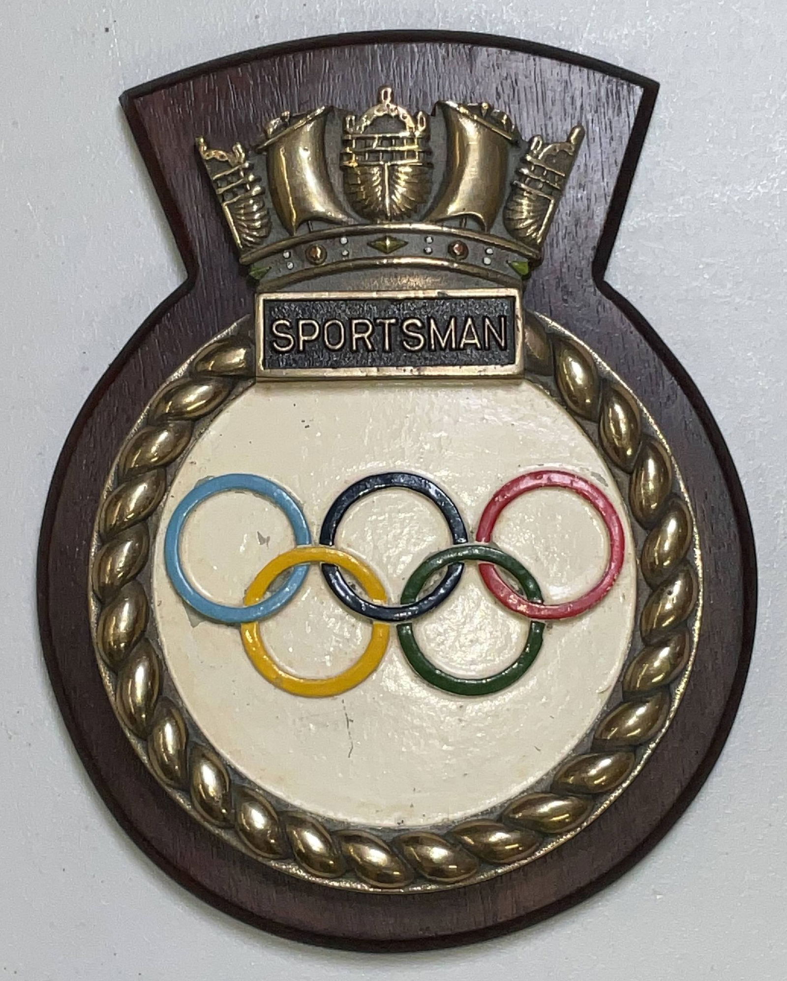 Fabulous British Royal Navy Screen Badge from HMS Sportsman: Submarine screen badge from the S-class submarine HMS Sportsman. (P229) was built at Chatham Dockyard in 1942. Heavy brass badge with polished edge, rope border, and naval crown at top. The olympic