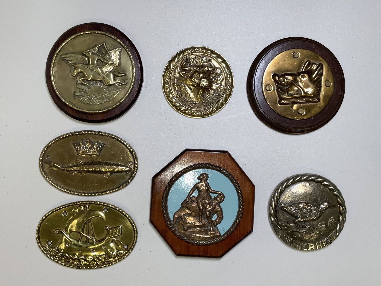 Ships Badges from British Royal Navy Ships Badges and Tompions: Quality group of ships badges and tompions from HMS Bellerophon, HMS Viribus, HMS Waterhen, HMS Vivien, HMS Sturgeon, HMS Argyll, and HMS Audacious. Very interesting group. 17 lbs 7 pcs. 8" diameter (