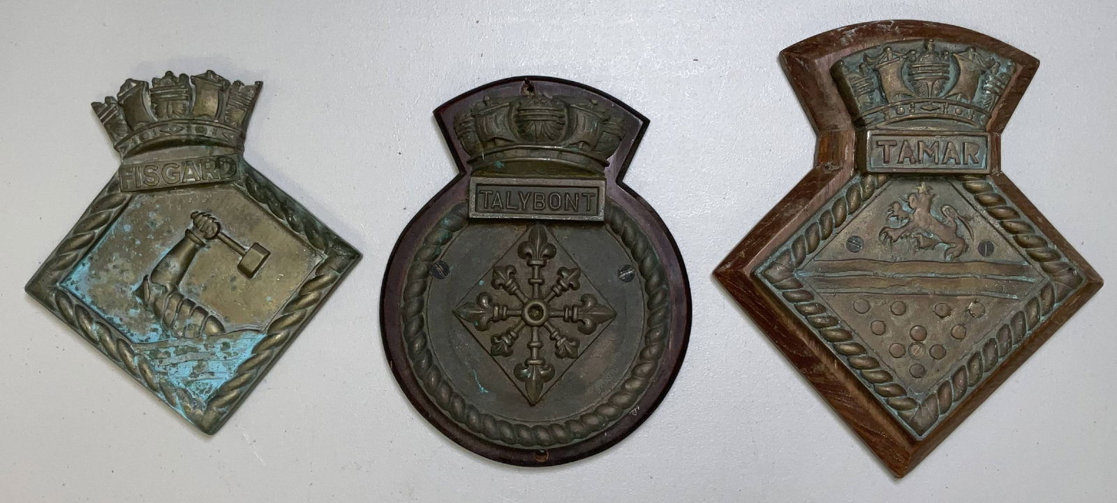 British Royal Navy Ships Badges and Gun Tompion: British Royal Navy ships badges from HMS Fisgard, HMS Talybont, and HMS Tamar. 22 lbs 3 pcs. 12"H x 10"W big. 9"H x 9"W small.