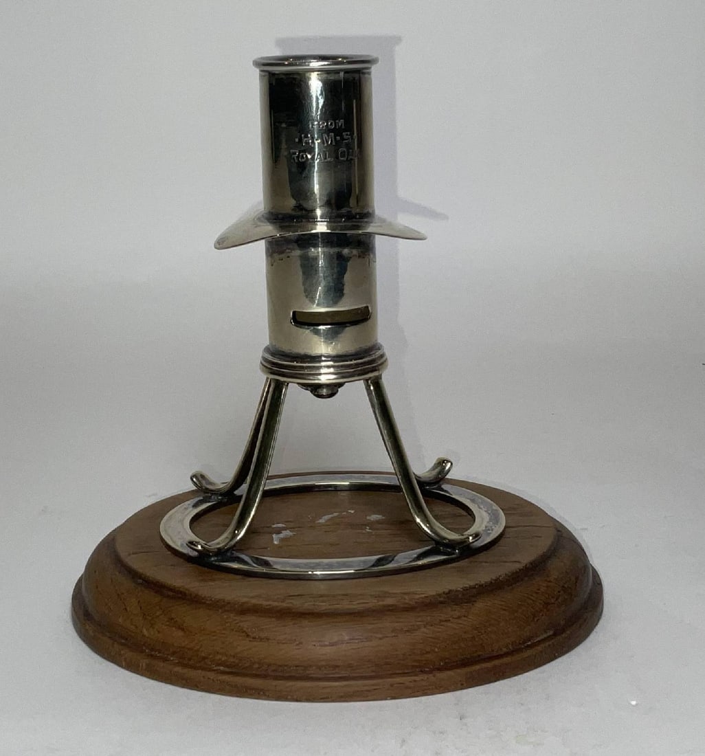 HMS Royal Oak Candlestick: Sterling candle holder engraved HMS Royal Oak with drip lip, four legs, and wood base. 2lbs. 7"H x 6"diameter