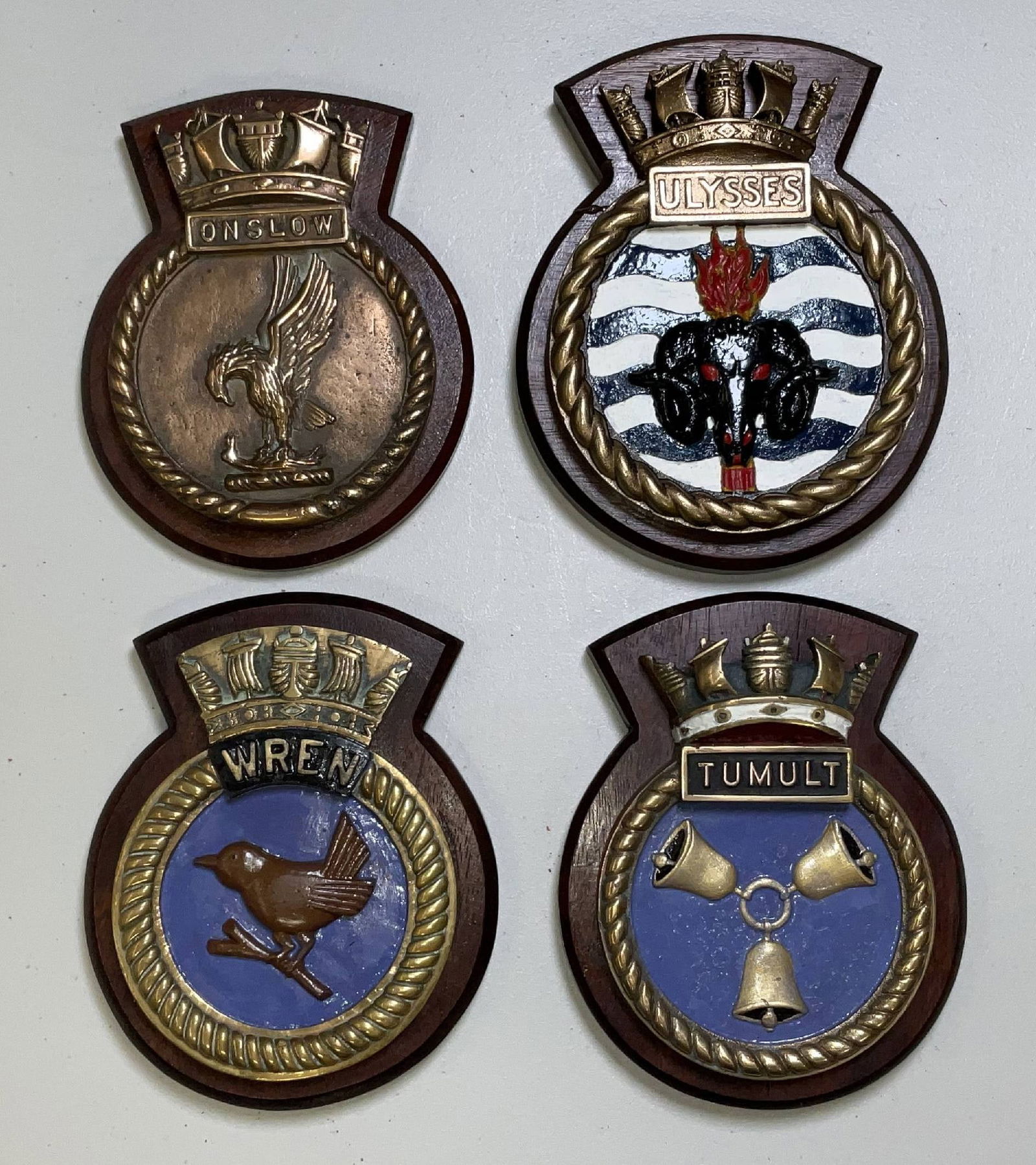 Four Solid Brass British Royal Navy Screen Badges: Four British Royal Navy ship screen badges, heavy cast brass crests from the destroyer HMS Onslow, U-class fleet destroyer HMS Ulysses, Admiralty destroyer HMS Wren of WWI, and HMS Tumult from Scapa F
