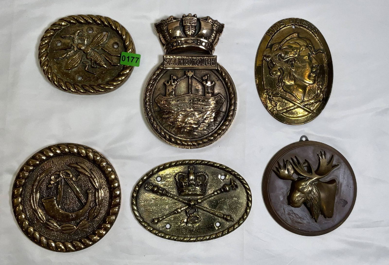 Brass Badges Representing British Royal Navy Warships: Ship's badges and plaques for HMS Horney, HMS Scarborough, HMS Orestes, HMS Canada, and others. 6 badges. 13 lbs. 9"H x 6"W big. 6"Diameter small.