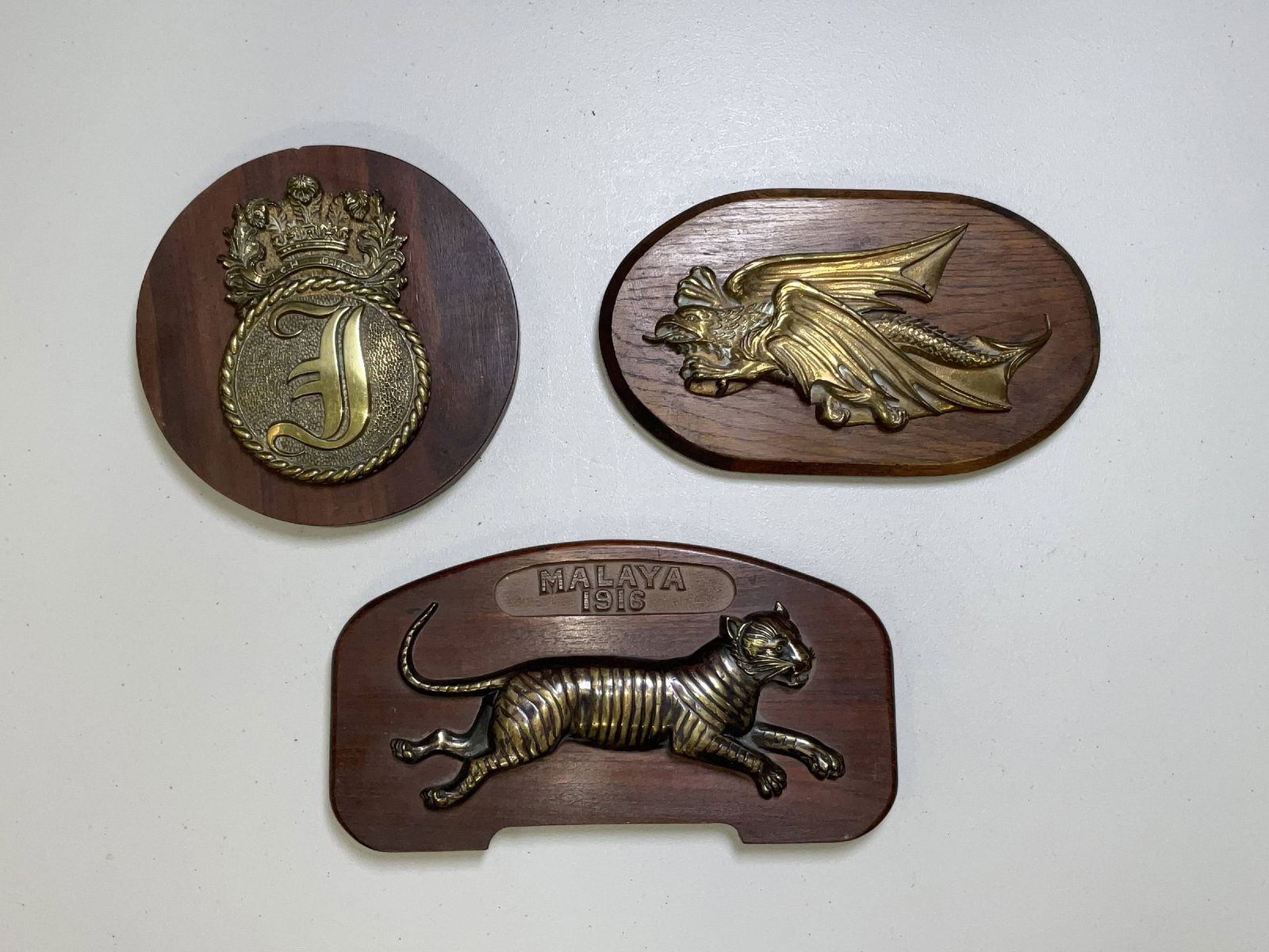 Three British Royal Navy Gun Tompions: HMS Indefatigable, HMS Malaya, and HMS Furious gun tompions and badge. Large F on a brass plaque for the Kamikaze-surviving aircraft carrier HMS Indefatigable, HMS Malaya, a Queen Elizabeth class