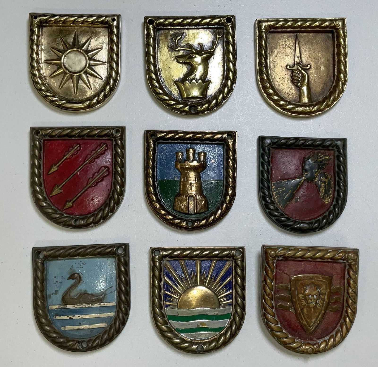 Nine Chatham Pattern Shield Shaped Royal Navy Badges: Nice group of nine shield shaped ships’ badges from English Royal Navy ships. HMS Volunteer, HMS Splendid, HMS Cygnet, HMS Boreas, HMS Worcester, HMS Velox, HMS Mackay, HMS Walker, and HMS