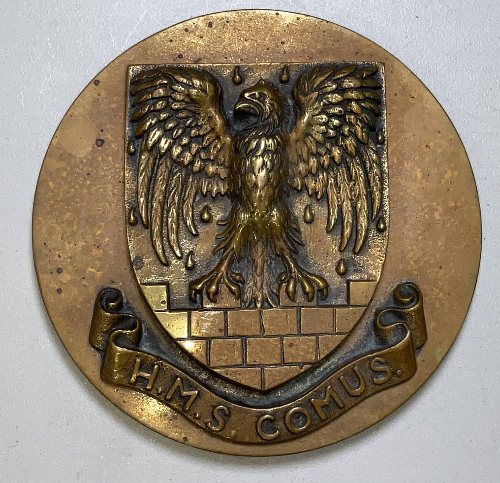 Thirteen Pound Gun Tompion from HMS Comus: Solid brass gun tompion from HMS Comus (R43), a C-class destroyer of the Royal Navy, built by Thornycroft at Southampton in 1945. Comus served in the Far East from 1947 to 1957, showing an eagle on a