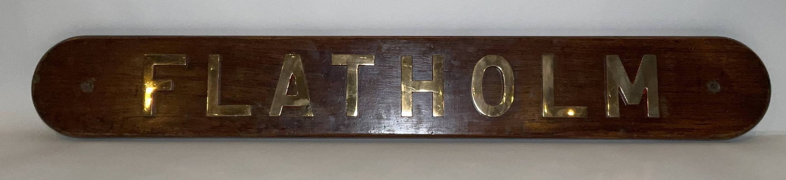 Royal Navy Ship’s Nameboard Flatholm: Ship’s nameboard from the Royal Navy escort destroyer HMS Flatholm (L14), a Hunt-class Type II destroyer launched in 1940 and commissioned during the Second World War. HMS Flatholm served primarily