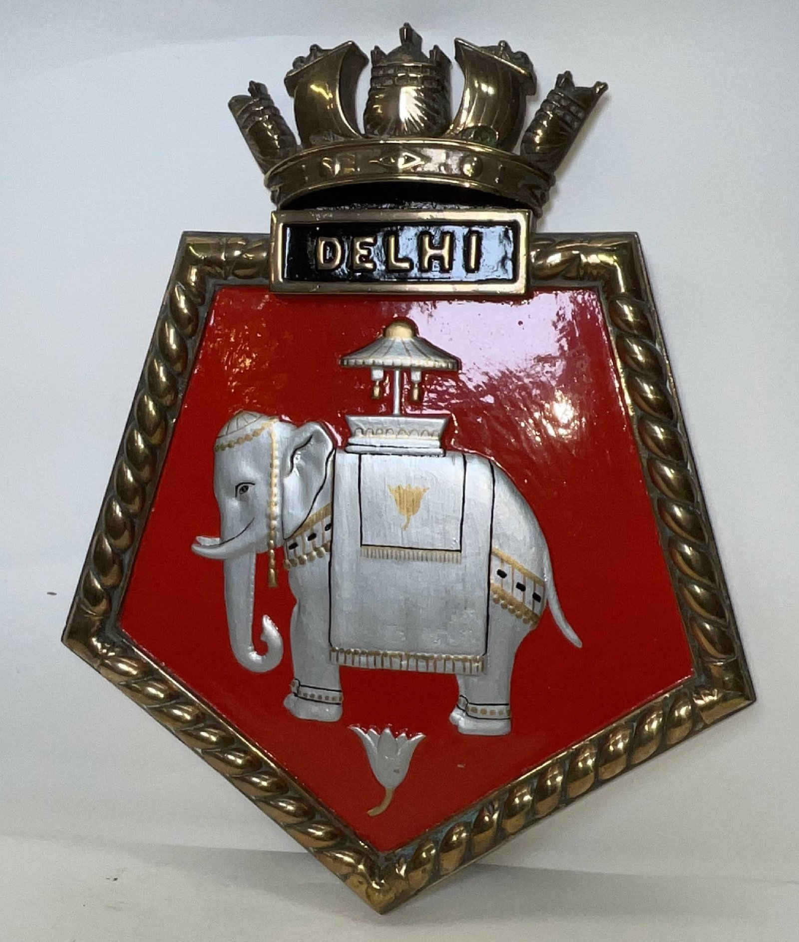 Cast Brass Screen Badge from HMS Delhi: HMS Delhi was a Royal Navy “Danae-class” light cruiser that served through the Second World War, from the Caribbean to eastern China, the Baltic, and Atlantic Fleet. She served as escort to