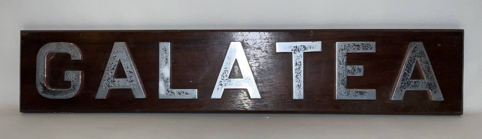 Royal Navy Ship’s Nameboard Galatea: Ship’s nameboard from the Royal Navy light cruiser HMS Galatea (71), a Leander-class cruiser launched in 1934 that saw active service during the early years of the Second World War. HMS Galatea oper