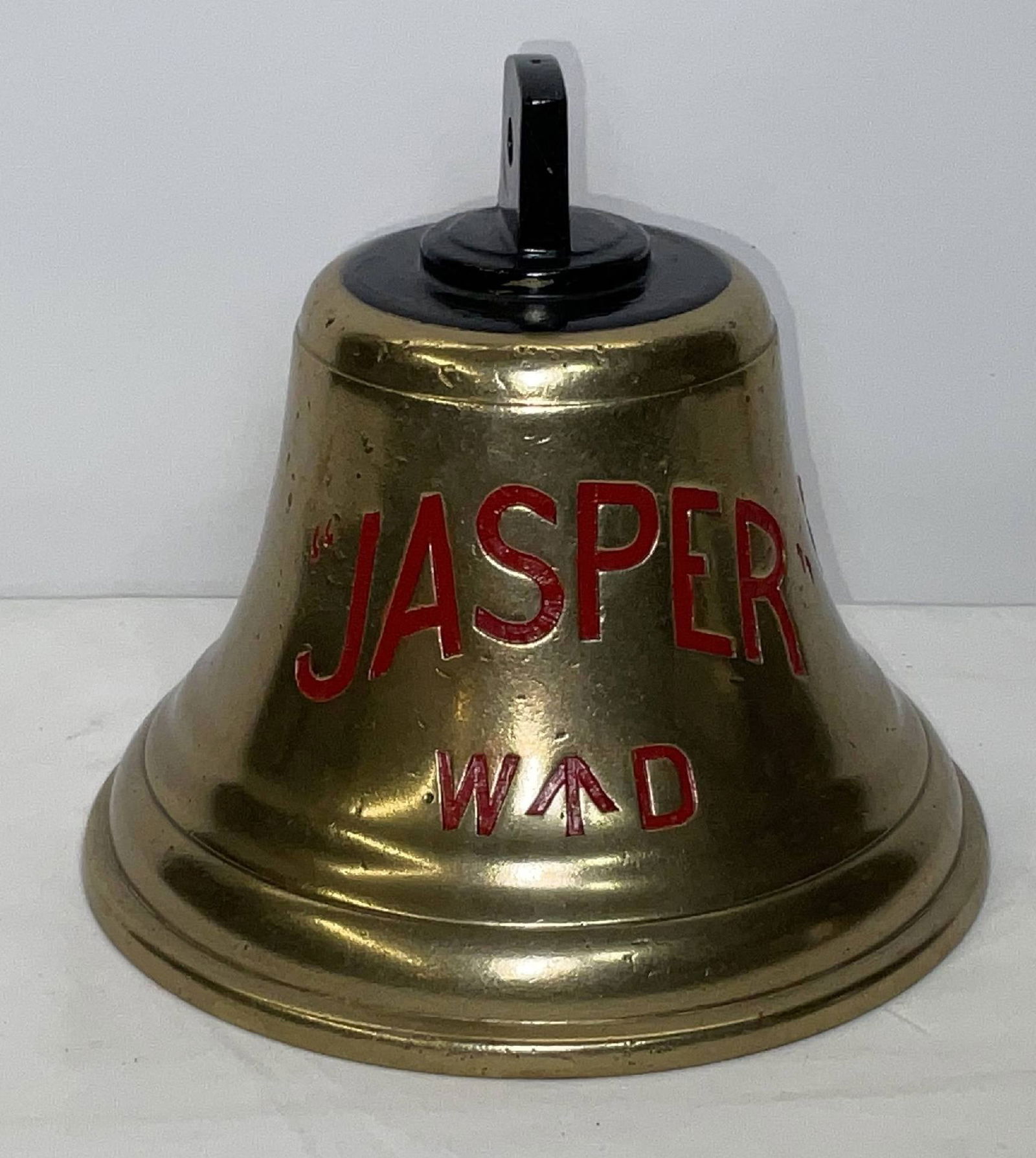 Bell from H.M.S. Jasper: Solid brass bell from the ship H.M.S. Jasper, engraved “JASPER”. H.M.S. Jasper (J?407) was originally laid down in 1943 as the U.S. built minesweeper BAM?29 and was renamed Jasper when transfe