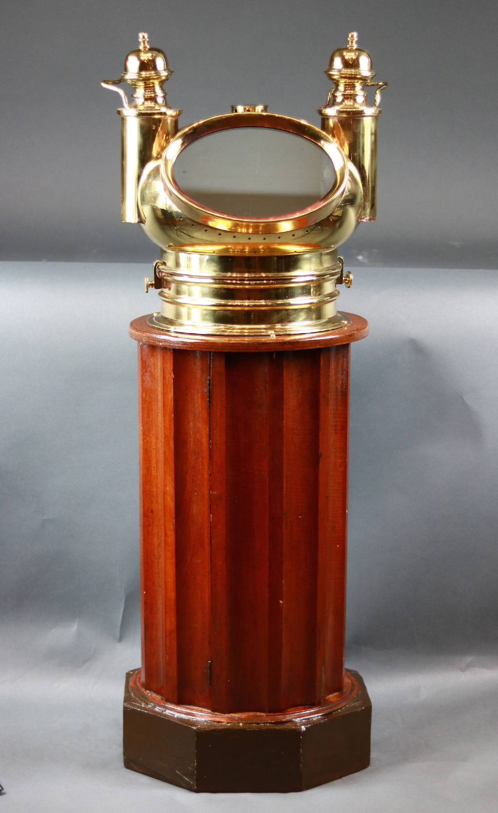 Negus | Brass Ship's Binnacle on Mahogany Stand: Late, 19th century ship's binnacle compass by Negus of New York. Turned, varnished mahogany stand with brass hood stamped "Negus New York". Hood has side burners to illuminate compass inside. Compass