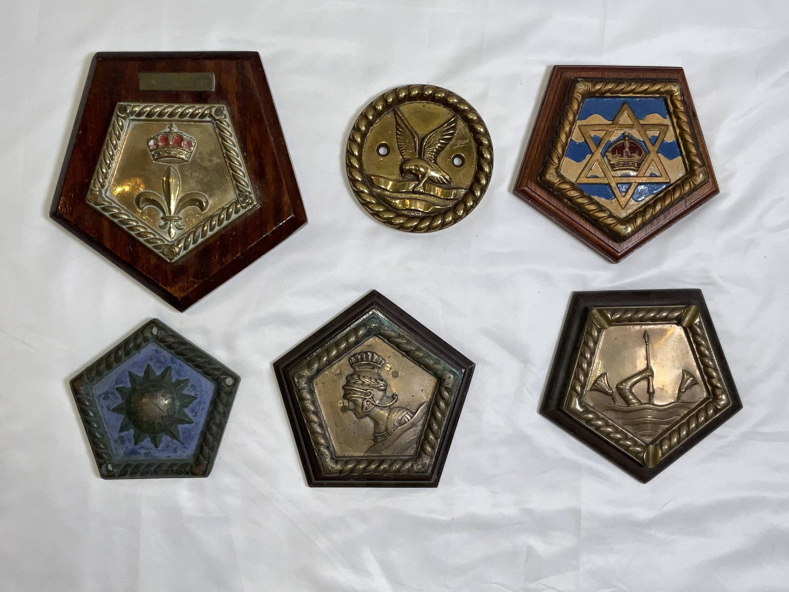British Royal Navy Ship's Badges from Six Warships: Ship's badges from HMS Royalist, HMS Tireless, HMS Nigeria, HMS Apollo, HMS Dauntless, and HMS Leander. 6 badges. 17 lbs. 9"H x 9"W big. 5"H x 5"W small.