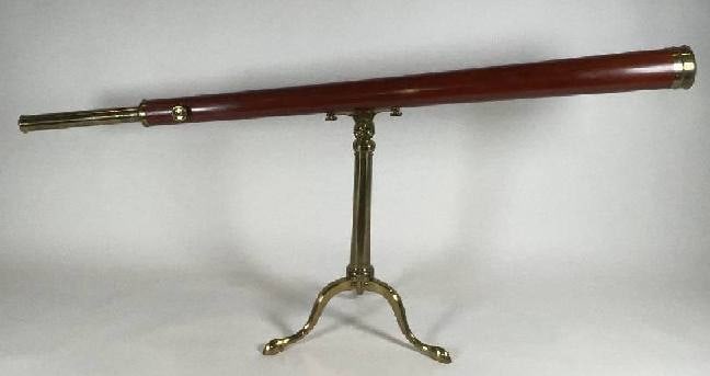 Dollond of London Telescope on Tripod: Wood barreled table top library telescope by Dollond of London. With long tapered wood barrel. Sturdy brass tripod with tapered pillar and mounting plate. Geared focal tube with two eyepieces. Fitted