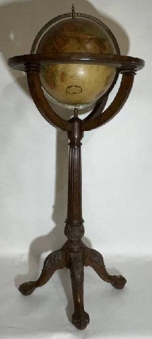 Maitland Smith Globe on Stand: World globe with brass horizon band. Intricately carved pedestal base with ball and claw feet. Quite detailed. By the famous Maitland Smith, globe itself is from Replogle. 62" H x 26" Diameter. 30