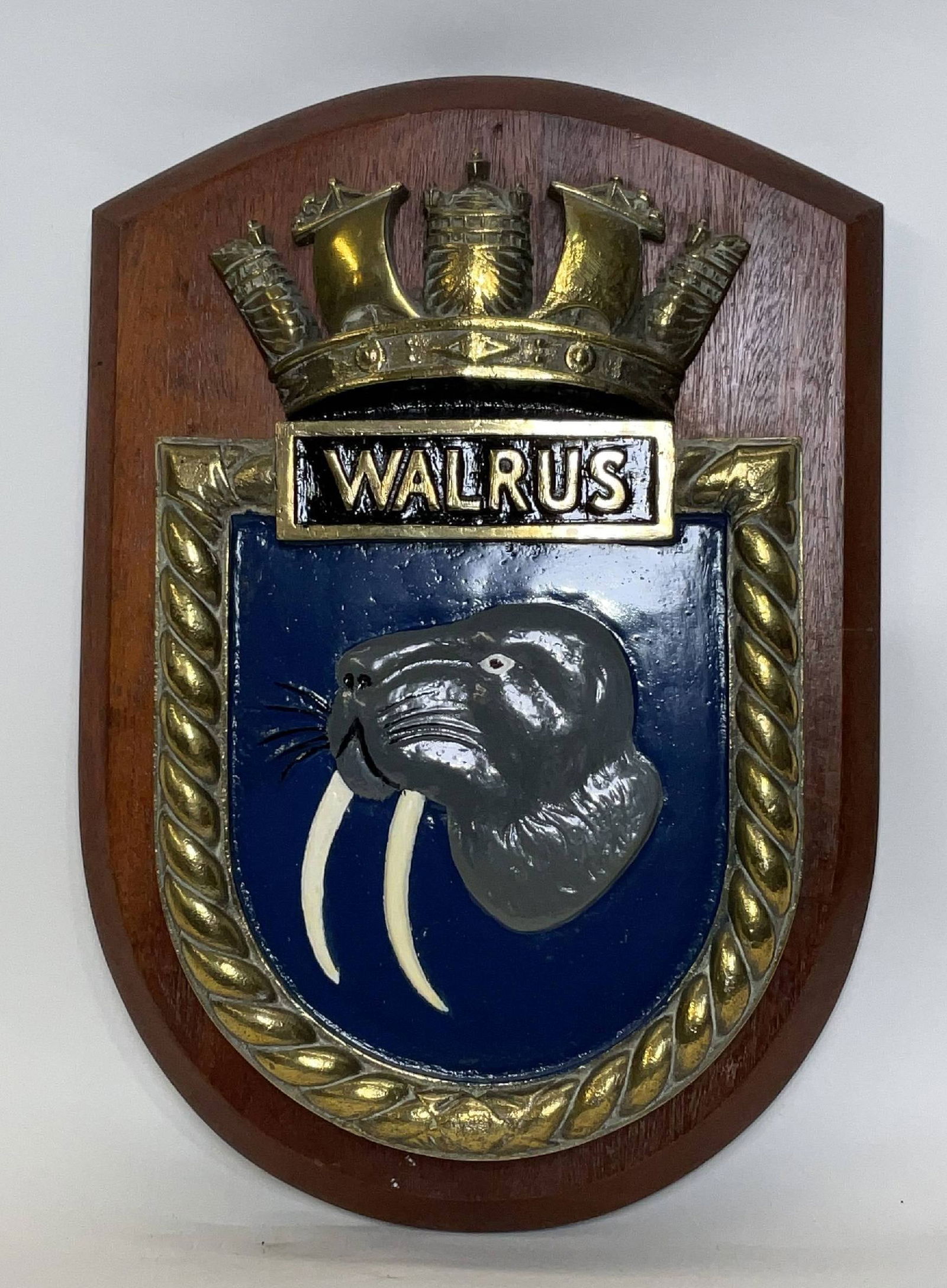 Solid Brass Screen Badge from HMS Walrus of 1945: British Royal Navy screen badge from the aircraft transporter HMS Walrus. The heavy badge shows a large walrus surrounded by rope and a naval crown. 15 lbs. 18" H x 12" W.
