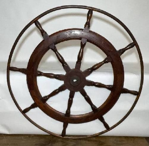 Ships Wheel with Ten Turned Spokes: Fine old ships wheel with inlaid brass band, iron hub, and outer ring. The oak wheel has a varnish finish. Ten turned spokes. 54" Diameter. 65 lbs.