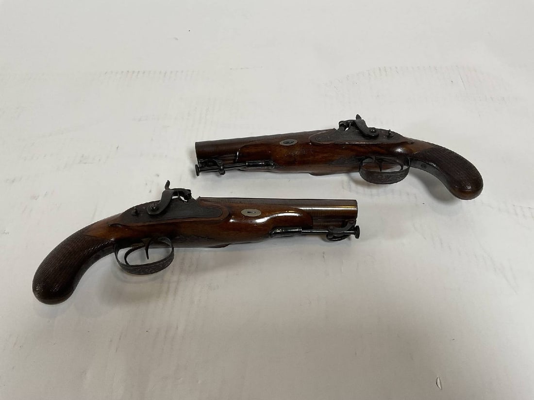 Pair of Early 19th Century Percussion Pistols: English made early 19th century percussion by W&S Rooke. Barrel is 6 1/2 inch solid rib. Stock is walnut. William and Samuel Rooke operated together from 1820 to 1837 in Birmingham, Bag shaped grips,