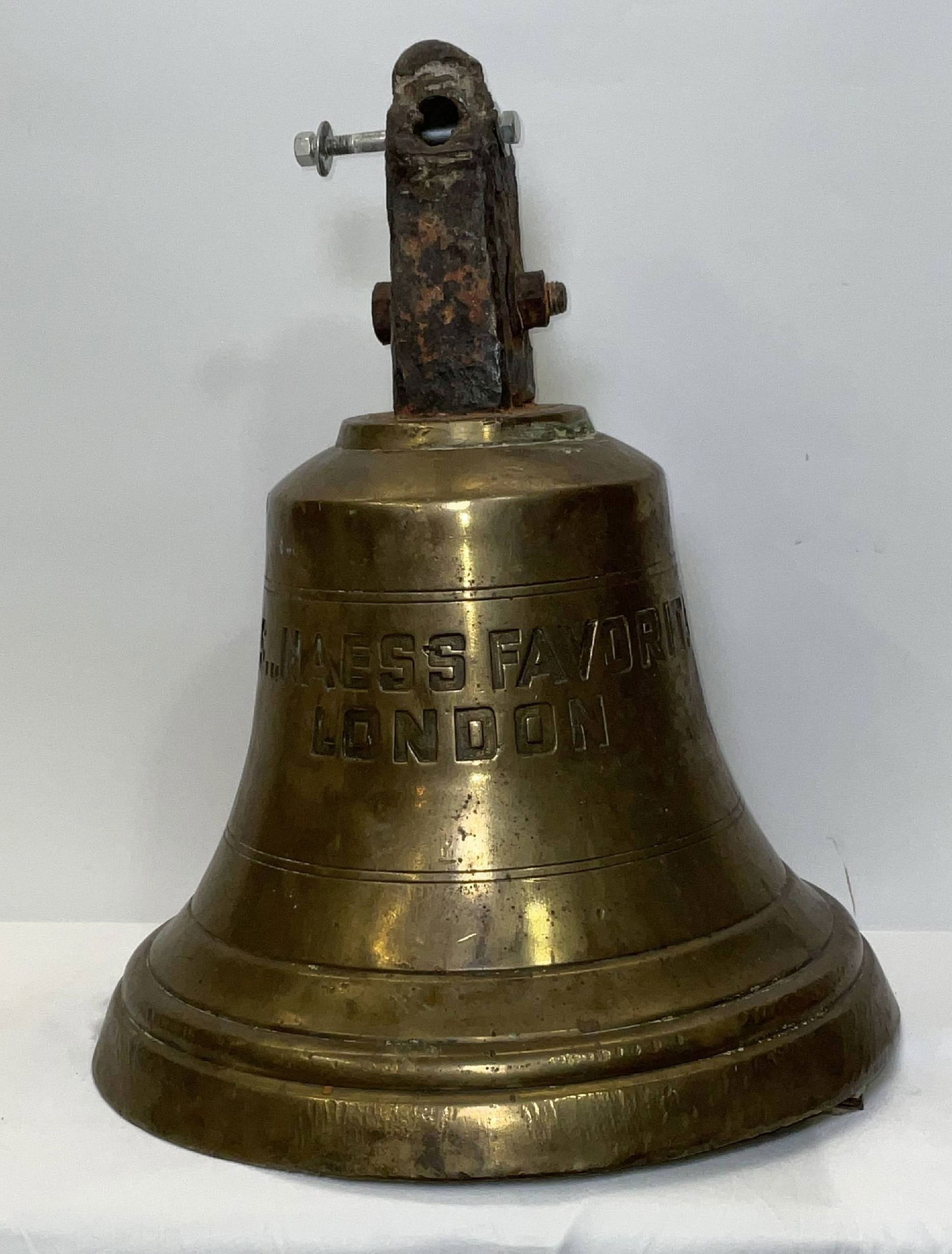 Ship Bell from the SS Naess Favorita of London: Heavy eighty-pound solid brass ship's bell from the Naess Favorita of London. Built by Flensburger Schiffbau Gesellschaft, Flensburg, Germany. She was a bulk carrier built in 1961. With original clapp