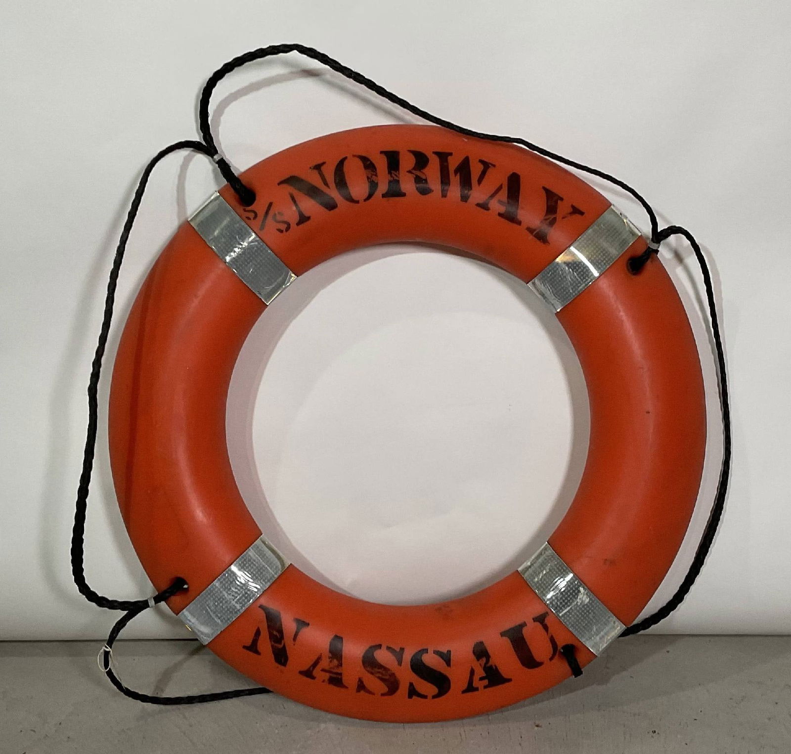 Ocean Liner SS Norway Lifering with Rope: Lifering from the ocean liner SS Norway of Nassau. Stencil painted onto a hard plastic lifering with rope. SS Norway was a legendary liner, originally the French Lines SS France. She was 1035 feet