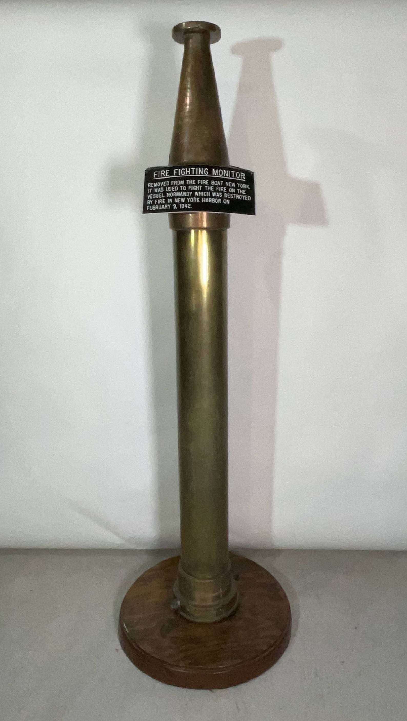 Solid Brass Fireboat Water Hose Monitor: Large and heavy solid brass fire nozzle from the Fireboat New York. With plaque reading "Removed from the fire boat New York." It was used to fight the fire on the vessel Normandy (Normandie) which