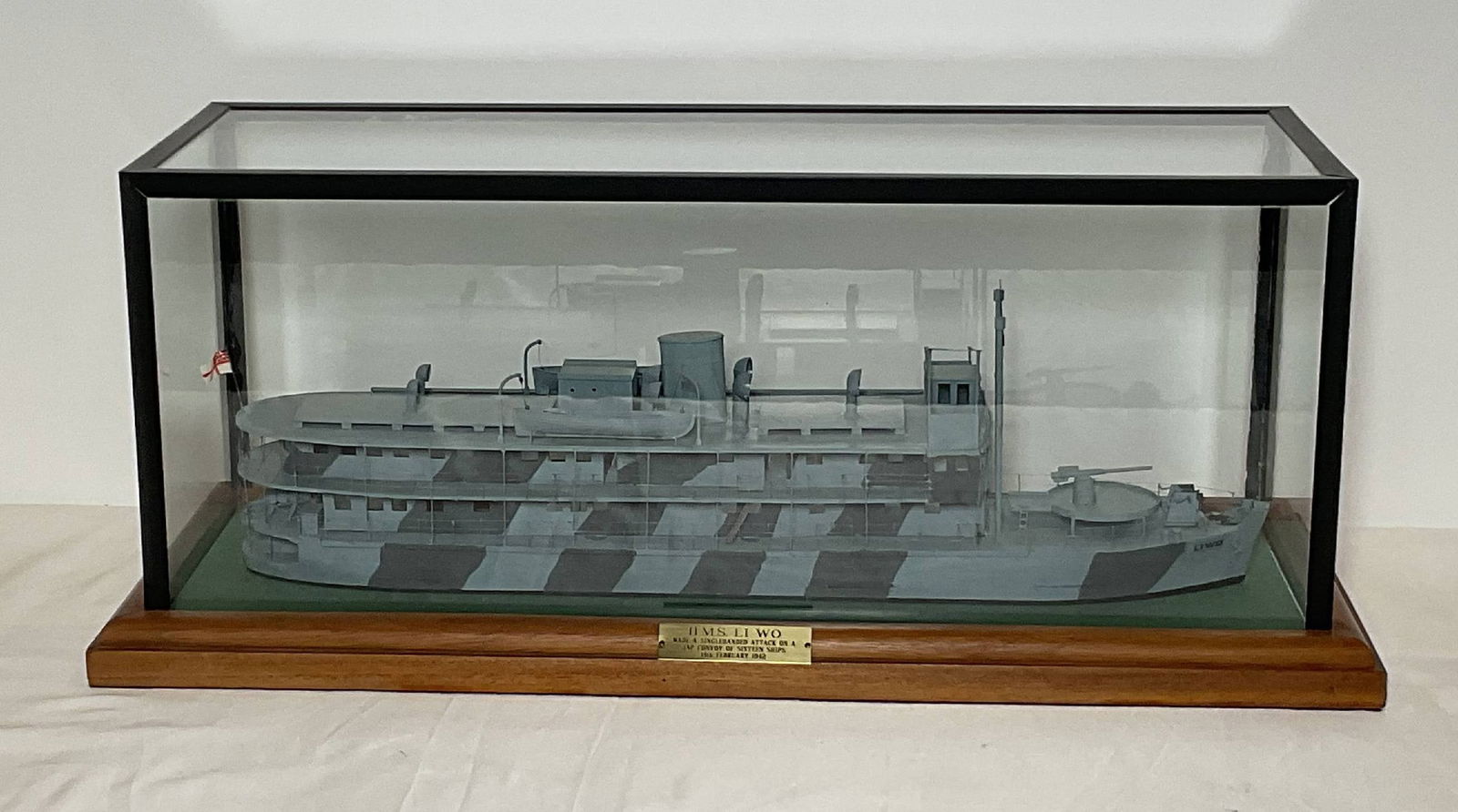 HMS Li Wo Ship model from World War II: Detailed ship model of the HMS Wi Lo. This vessel made a single-handed attack on a convoy of sixteen ships last 14 Februrary 1942. Painted in camouflage paint. Waterline model with case. 11"H x 26"W
