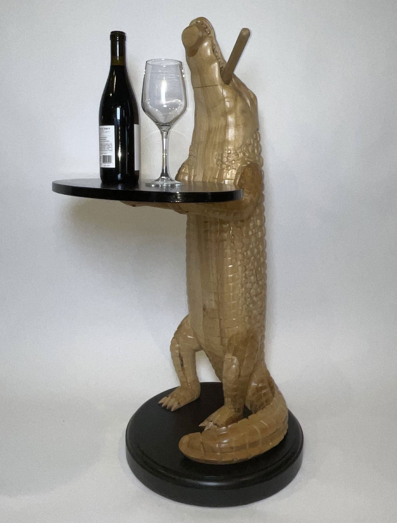 Carved Wood Alligator with Cigar: Hand carved alligator holding a tray with a cigar in its mouth. Very detailed with a varnish finish. The base and tray are made of rich mahogany. Wonderful craftsmanship and a fun accent piece. 29 lbs