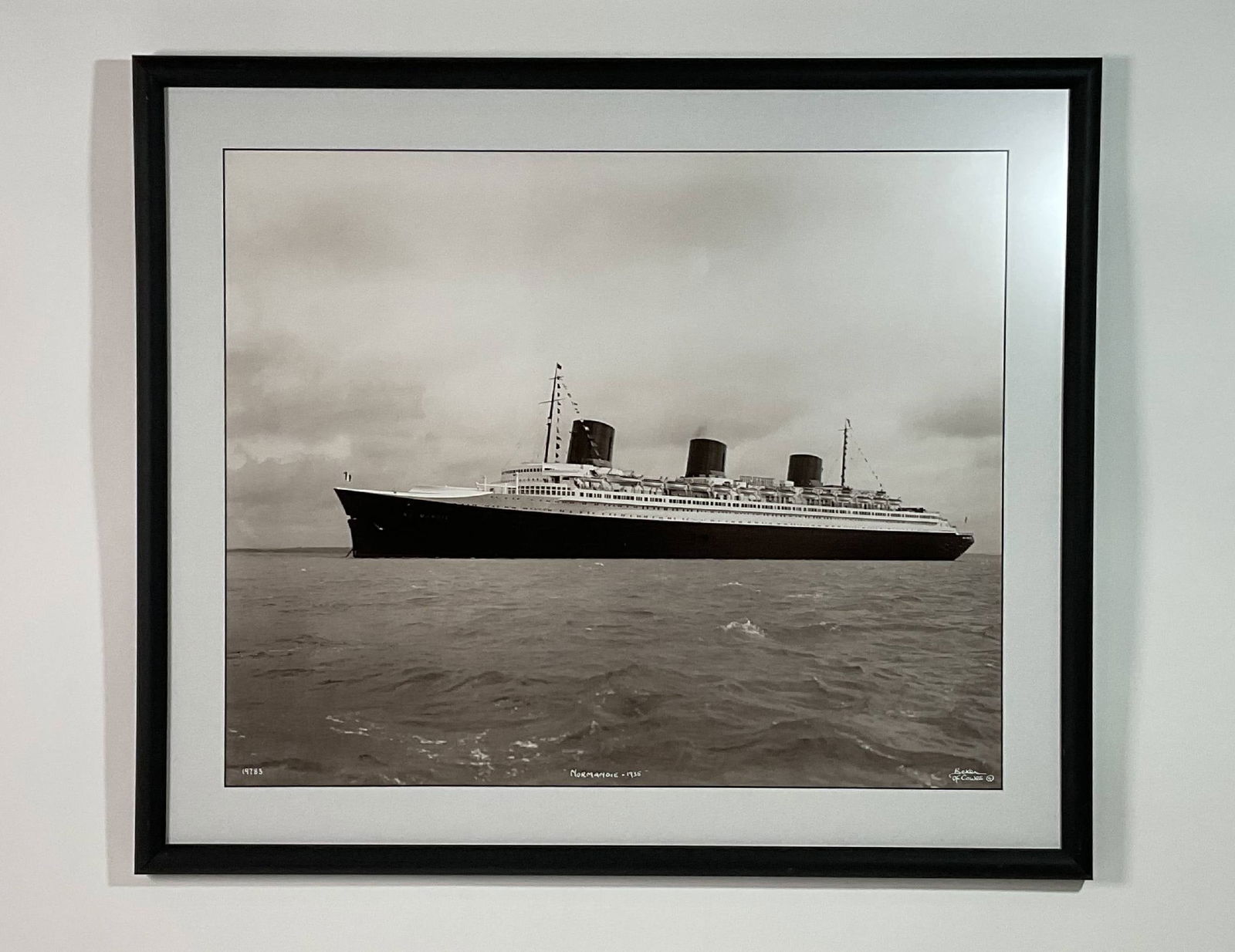 Photoprint of French Line Liner Normandie by Beken of Cowes: Ocean liner Normandie photoprint by Beken of Cowes. In modern frame. Age of poster unknown. 6 lbs. 25" H x 29" W.