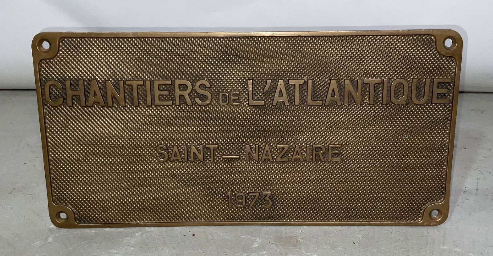 Shipbuilders Plaque from Chantiers De L'Atlantique of Saint Nazaire: Shipbuilders plate from "French Shipyard Chantiers De L'Atlantique of Saint-Nazaire, 1973". Cast brass plate with four mount holes. Chantiers De L'Atlantique is the largest shipyard in Europe and is