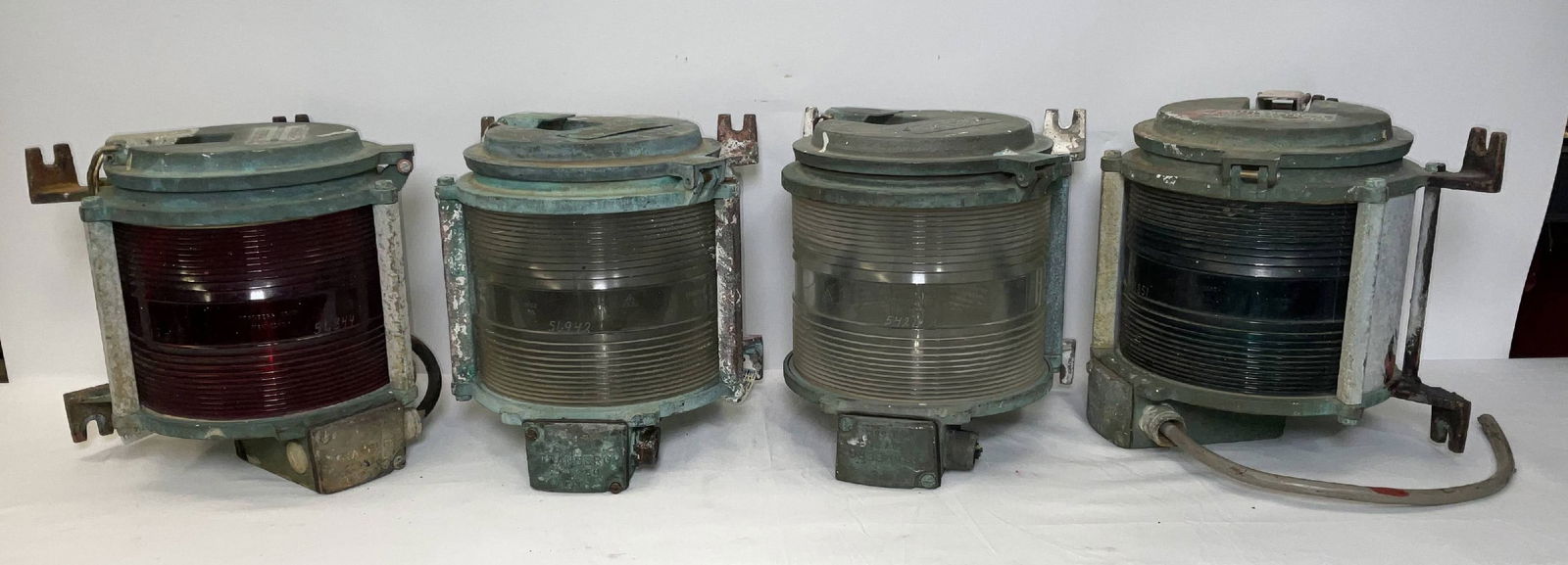 Group of Four Marine Beacons by Tramberg as a Lot: Four nautical lanterns by Tramberg with rippled lenses. Two are clear, one red and one green. Removeable tops with hasps. Flanges for mounting.