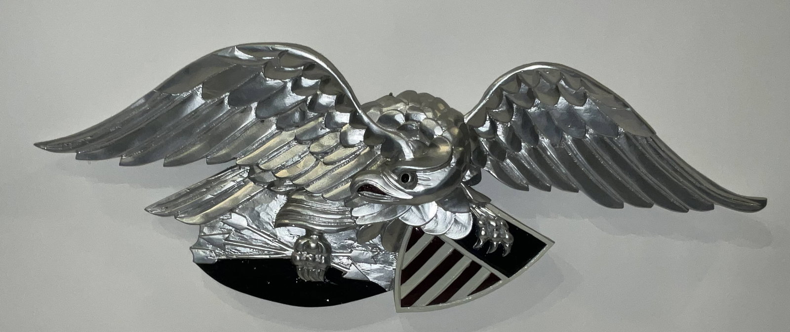 Carved Wood Eagle of Louisburg Style: Louisburg style carved american eagle with patriotic badge in its talons. 5lbs. 9"H x 25"W