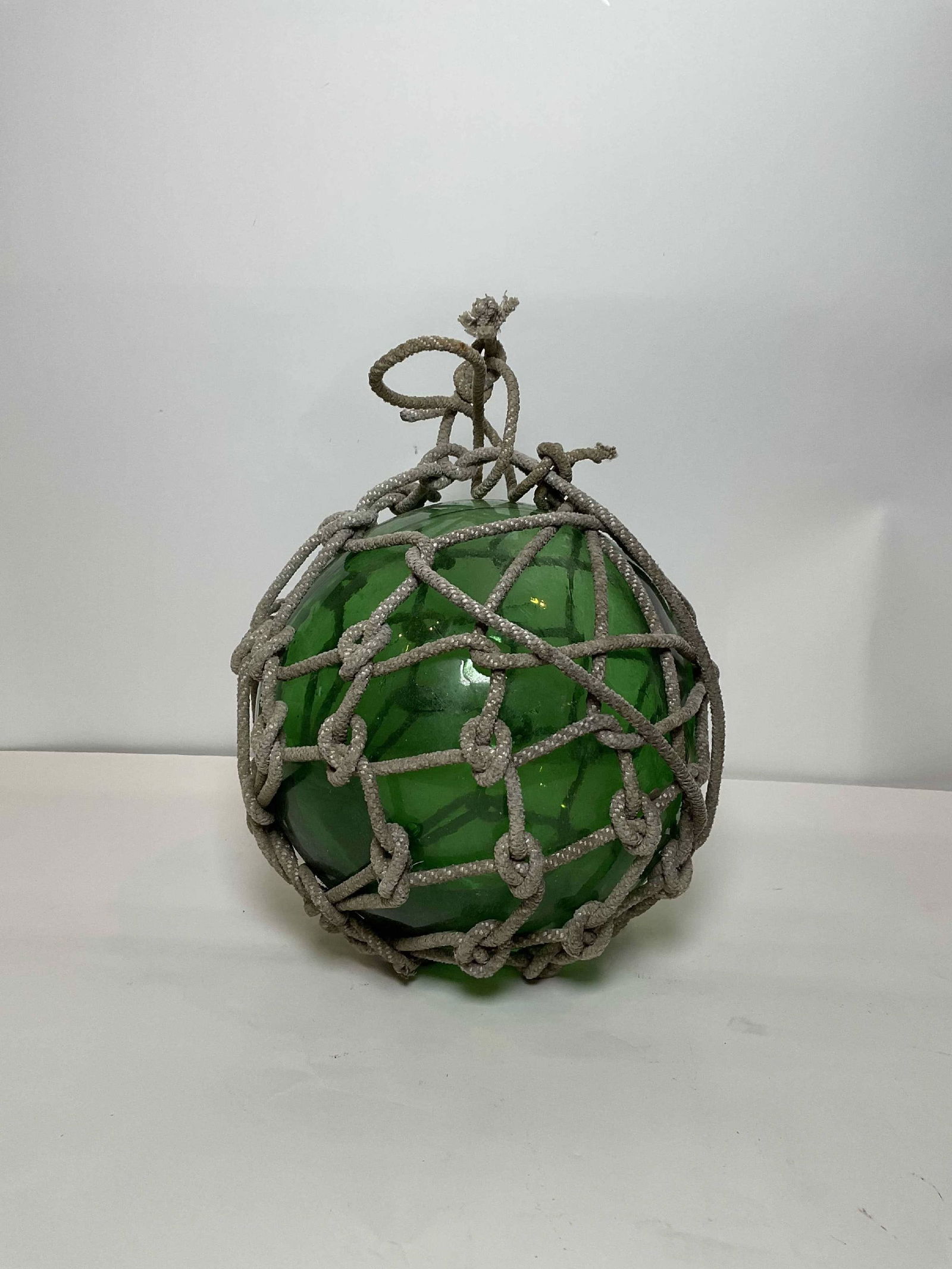Authentic Blown Glass Net Float: Authentic blown glass fishermans net float or tuna ball. Intricate rope cover on ball with knotted tie-off. Large and sturdy. 5 lbs. 12" Diame