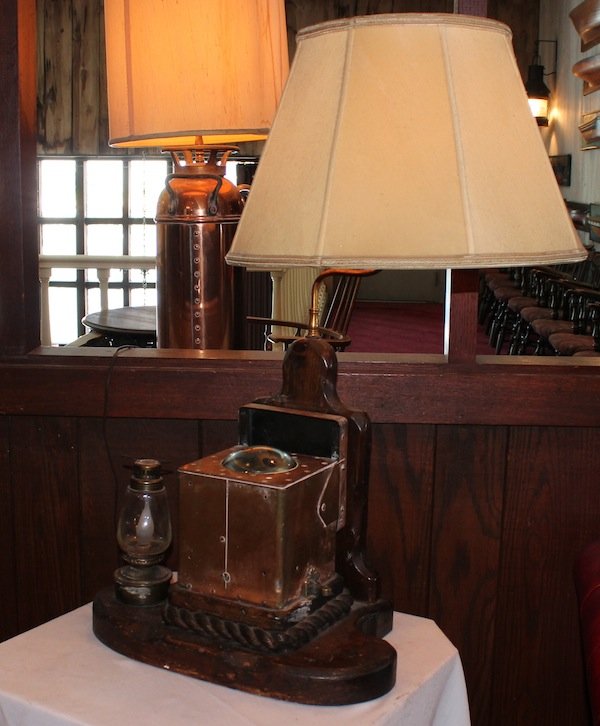 Nautical table lamp from Anthony's Pier 4: Handcrafted table lamp with copper ship’s compass and oil lamp. This item decorated the tables of Anthony's Pier 4 in Boston Harbor.