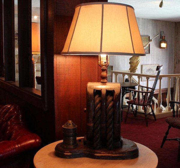 Nautical table lamp from Anthony's Pier 4: Lamp crafted from a ship’s pulley with rope and side light of brass. 18” wide x 34” tall. This item decorated the tables of Anthony's Pier 4 in Boston Harbor.