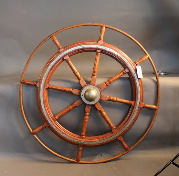Ship’s wheel with outer ring: Eight spoke ship’s wheel with outer trim ring. and iron hub with turned spindles. 52” diameter.