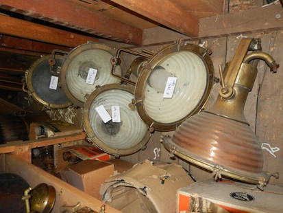 Five copper and brass ship’s floodlights: Five copper ship’s cargo lights with brass yokes