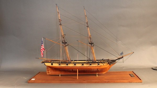 Twelve Gun Brig “Bainbridge”: Fine cased model of the twelve gun brig “Bainbridge” 1842. Plank on frame construction with exposed ribs. All cannon are rigged to the bulwarks with block and tackle. Expertly rigged. Mounted in a