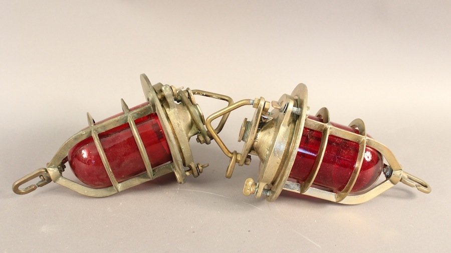 British Royal Navy Convoy Lights: Pair of solid brass British Royal Navy ship's convoy lights. Fitted with ruby red lenses, hoisting rings and bayonet sockets. 7" diameter x 12" tall